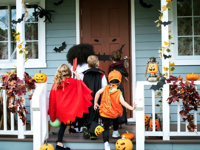 Image showing children going door to door for Halloween.